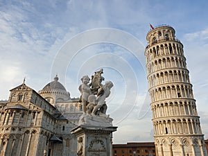 The leaning tower of Pisa and Piazza dei Miracoli in a sunny day - The Miracle Square, the Leaning Tower and the Cathedral is