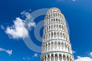 Leaning Tower Torre di Pisa on Piazza del Miracoli square, blue sky with white clouds background