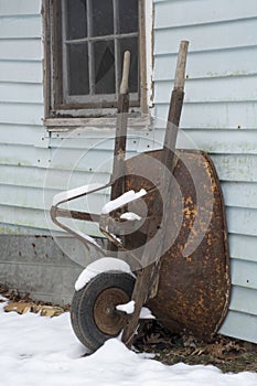 Leaning wheel barrow in wniter