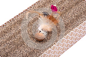 Leaps & Bounds Ball with Feather Cat Toy on reversible cat scratcher made of 100% recycled cardboard. Cat Toys for Scratching