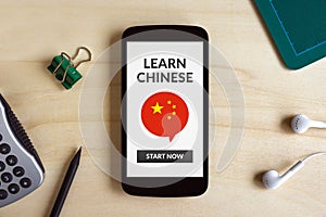 Learn Chinese concept on smart phone screen on wooden desk