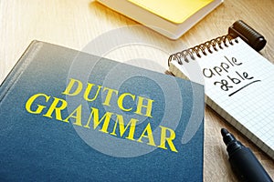 Learn dutch grammar. Book on a table.
