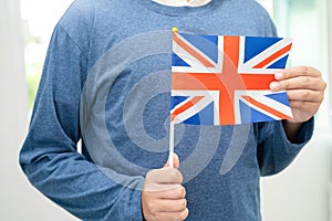 Learn English language, Asian teenage student hold UK flag in course at school