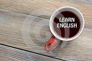 Learn English Text written on coffee cup. Office desk table top view