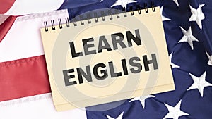 Learn English text written on a notebook page