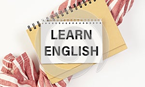 Learn English Text written on notebook page.