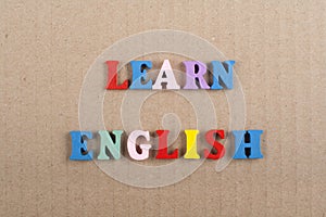 LEARN ENGLISH word on paper background composed from colorful abc alphabet block wooden letters, copy space for ad text