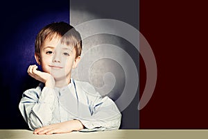 Learn french language concept. Happy child student with flag Fra