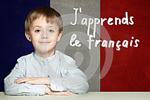 Learn french language concept. Happy child student and tittle photo