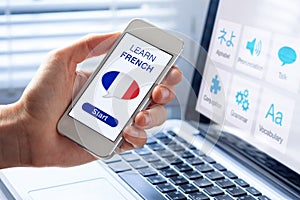 Learn French language online concept, mobile phone, flag of France