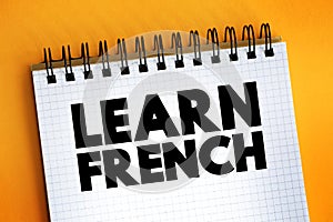 Learn French text on notepad, concept background