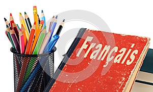 Learn French, textbook and pencils isolated