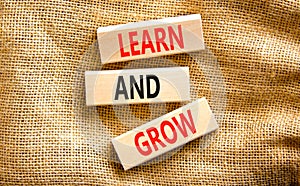 Learn and grow symbol. Concept word Learn And Grow on beautiful wooden block. Beautiful canvas table canvas background. Business,
