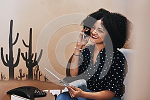 Learn how to handle business over the phone as well. a young female designer making a phone call while holding a digital