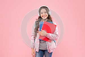 Learn the language you want. Happy child wear headphones holding books. English school. Foreign language courses. Audio