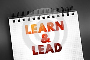 Learn and Lead - helps new managers make the transition from individual contributors to effective leaders, text concept on notepad
