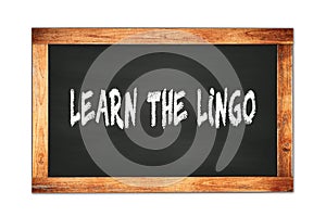 LEARN  THE  LINGO text written on wooden frame school blackboard photo