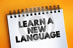 Learn A New Language text quote on notepad, concept background