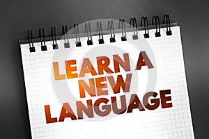 Learn A New Language text quote on notepad, concept background