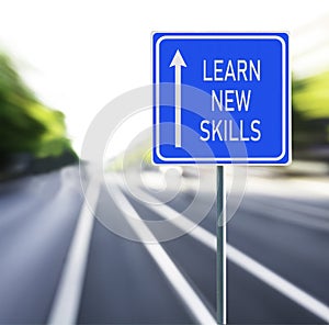 Learn New Skills Road Sign on a Speedy Background.