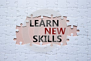 Learn new skills symbol. Concept words Learn new skills on white puzzle. Beautiful pink background. Business and Learn new skills