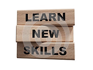 Learn new skills symbol. Concept words Learn new skills on wooden blocks.Learn new skills concept.