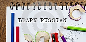 Learn Russian text written on a paper with pencils in office