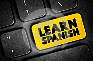 Learn Spanish text button on keyboard, concept background