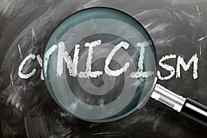 Learn, study and inspect cynicism - pictured as a magnifying glass enlarging word cynicism, symbolizes researching, exploring and