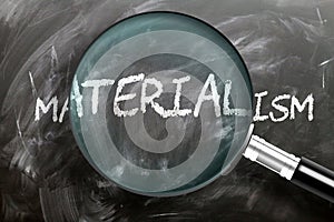 Learn, study and inspect materialism - pictured as a magnifying glass enlarging word materialism, symbolizes researching,