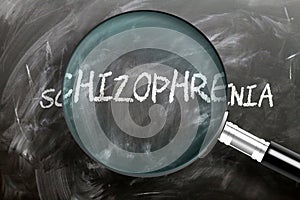 Learn, study and inspect schizophrenia - pictured as a magnifying glass enlarging word schizophrenia, symbolizes researching,