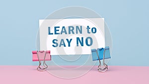 Learn to say no - concept of text on business card. Business card on pink and blue background