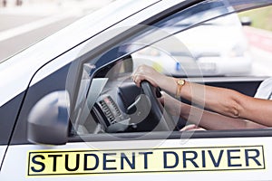 Learner driver holding steering wheel during driving lesson