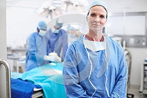 Learning from the best. Portrait of a confident mature female doctor wearing her hospital scrubs standing in an