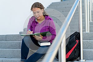 Learning blond female student at stairs