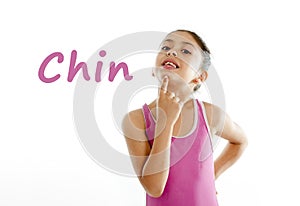 Learning body parts school card of girl pointing at her chin on white background photo