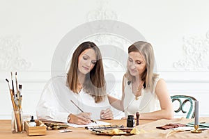 Learning calligraphy in art workshop. Teacher and students. Art school handwriting.