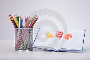 Learning concept with letters, book and pencils