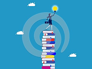 learning creates opportunities and wisdom for creative thinkers. Businesswoman on a high stack of books with a light bulb