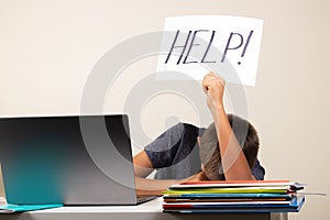 Learning difficulties, school, education, online remote learning concept. Sad kid with laptop computer holding card with