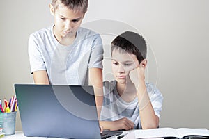 Learning difficulties, school, remote education, online learning at home. Two kids using laptop computer together