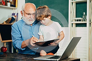 Learning and education concept. Grandfather and grandchild. Little ready to study. Portrait of grandfather and grandson