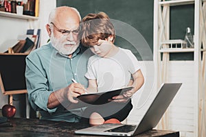 Learning and education concept. Grandfather and grandchild. Little ready to study. Portrait of grandfather and grandson