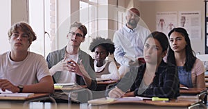 Learning, education and teacher in classroom of students listening to presentation in class. A professor teaching young