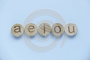 Learning english concept.Vowels of AEIOU on a blue background photo