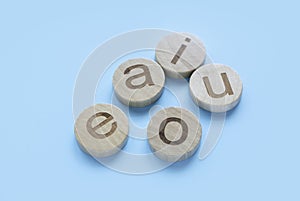 Learning english concept.Vowels of AEIOU on a blue background photo