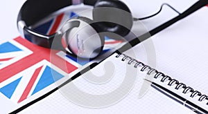 Learning foreign languages. Notepad for entries and a flag. Lang