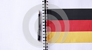 Learning foreign languages. Notepad for entries and a flag. Lang