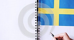 Learning foreign languages. Notepad for entries and a flag. Lang