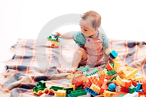 Learning through game. Little baby play construction game. Little child enjoy learning game. Adorable small baby playing